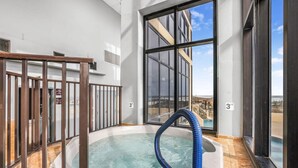 A hot tub with a blue hose, a view of a building, and a 3 FT height sign. - Phoenix II 2101 3 Bedrooms Amenities Galore Beachfront (Orange Beach)
