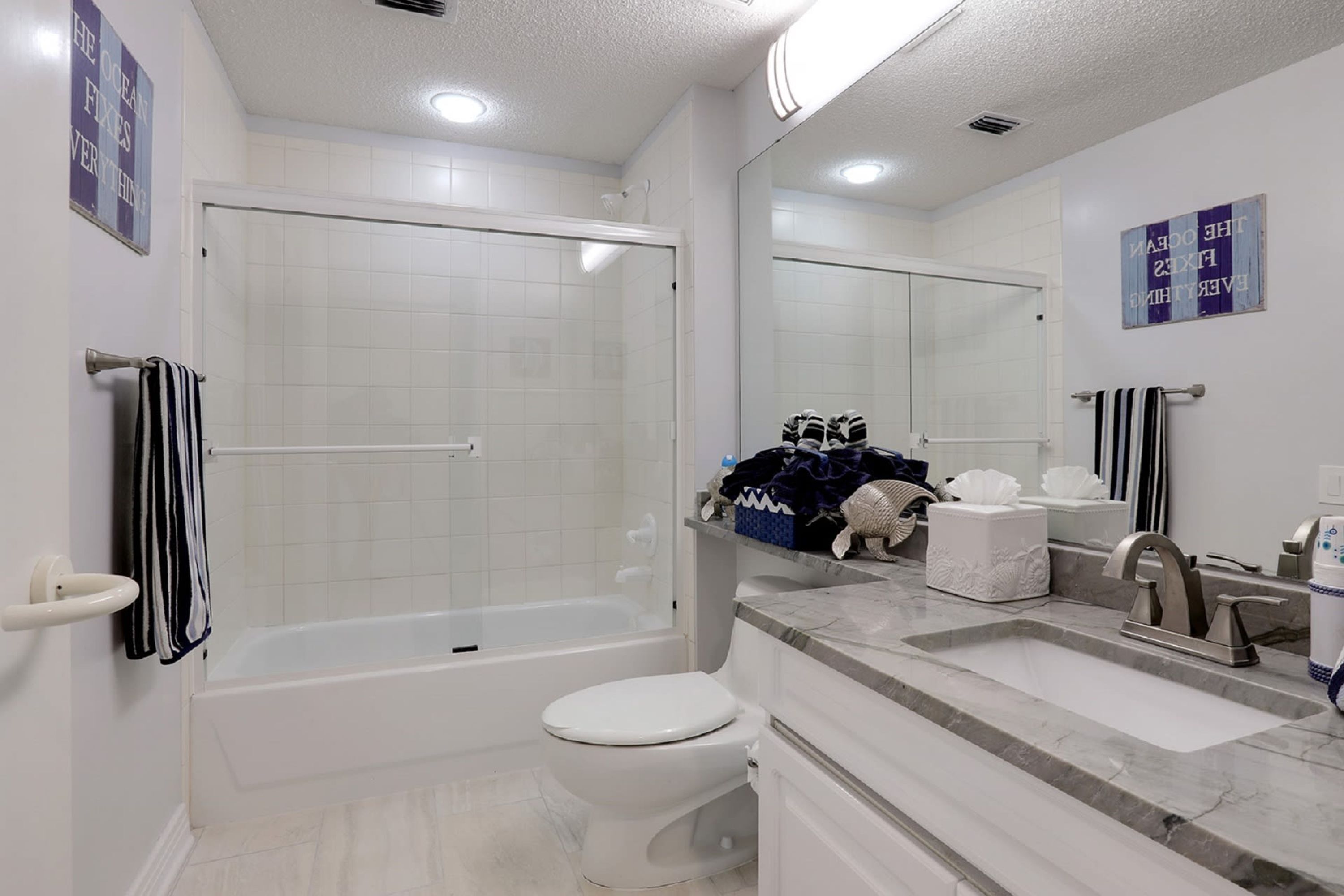 A modern bathroom with a bathtub, toilet, and sink.