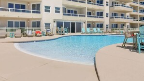 A multi-story hotel with a swimming pool, outdoor seating, and balconies. - Enclave 401 Beachfront Tennis Stunning Views (Orange Beach)
