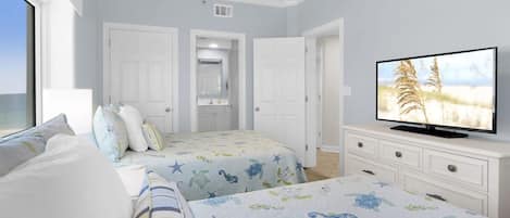Un dormitorio con dos camas, televisión y cómoda.