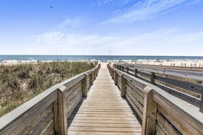 A wooden boardwalk leading to a beach with a clear sky. - Enclave 401 Beachfront Tennis Stunning Views (Orange Beach)