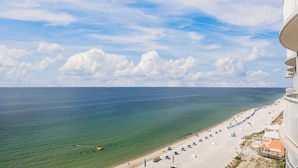 A coastal hotel with a beach view, clear skies, and a calm sea. - Island Royale- Beachfront Penthouse (Gulf Shores)