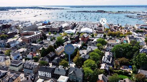 A coastal town with a marina filled with boats, historic buildings, and a prominent sign for "Royce". - The Royce on Spring - High-end Family Getaway in Newport (Newport)