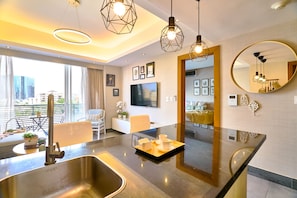 A modern kitchen with a large island, stainless steel sink, and pendant lighting. - Piantini Views Downtown SD Gym Lounge Pool (Santo Domingo)