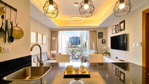 A modern kitchen with a central island, a built-in sink, and overhead lighting. - Piantini Views Downtown SD Gym Lounge Pool (Santo Domingo)