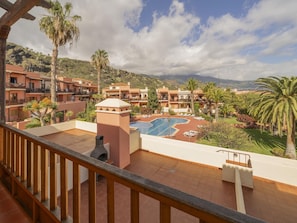 A resort with multiple buildings, a swimming pool, and palm trees. - La Mareta Cozy Apartment With Pool (Brena Baja)