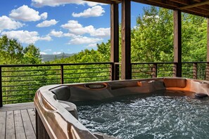 A hot tub on a wooden deck with a view of lush greenery and mountains in the background. - New Listing Discount-Luxury-Modern-Mountain and Lake View w/ Jacuzzi & Fireplace (Blue Ridge)