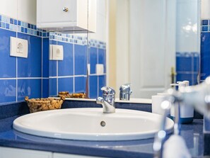 A bathroom with a white sink, blue tiled walls, and a mirror. - CHL La Concepci n Adeje Amazing sea Views (Adeje)