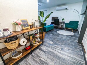 A modern living room with a sofa, a coffee table, a TV, and a plant. - San Jose Studio • Near PayPal Park • EV & BBQ (San Jose)