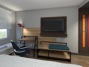 Una habitación moderna con una cama, un escritorio, una silla y un televisor montado en la pared.
