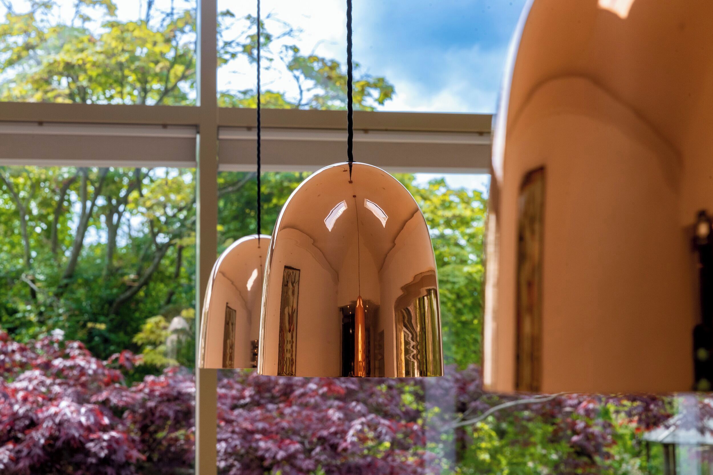 A modern building with arched windows and a hanging light fixture.