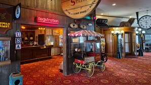 A vintage-themed interior with a registration desk, a vintage cart labeled "The Creoles," and a sign reading "The Overland Station." - The Tonopah Station  (Tonopah)
