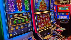 A row of slot machines with various denominations and bonus features. - The Tonopah Station  (Tonopah)