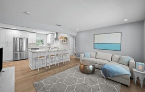 A modern kitchen with white cabinets, stainless steel appliances, and a bar area. - Marvelous 3-bedroom house with AC in charming Palm Harbor/ Ozona (Palm Harbor)
