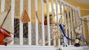 A nautical-themed decor with a ship's wheel, a red starfish, striped flags, and seashells. - Apartments Ivo Rovinj - Two bedroom apartment (Enzo) (Rovinj)