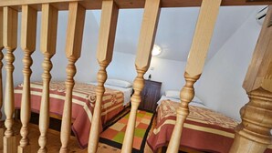 A room with two beds, wooden railings, and a nightstand. - Apartments Rubić - TwoBedroom Apartment with Loggia and SeaView (4) (Omis)
