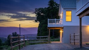 A house with a balcony, a gravel driveway, and a view of the mountains. - Lakeview Retreat Near Finger Lakes! (Lawrenceville)