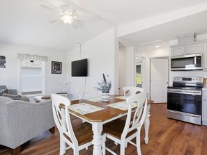 A modern kitchen with white cabinetry, a built-in microwave, and a stainless steel oven. - Lakeview Retreat Near Finger Lakes! (Lawrenceville)