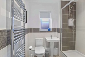 Shower, hair dryer, towels, shampoo
