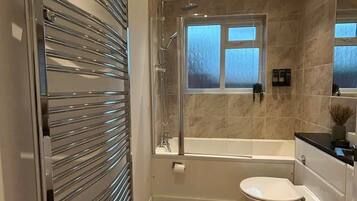 Shower, hair dryer, towels, shampoo