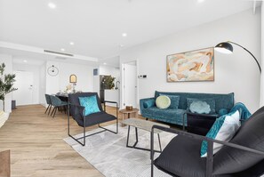 TV, books - Southport 2BR Retreat | Rooftop Infinity Pool (Southport)