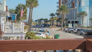 A coastal street with a view of a hotel and parked cars. - Beachside Oasis I Walk to the Beach I Ocean view I (Jacksonville Beach)