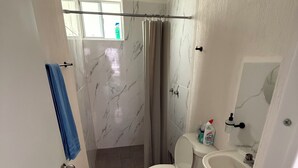 A bathroom with a toilet, sink, and shower. - Tranquil 2-bedroom apartment with AC in welcoming Tulum (Tulum)