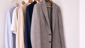 A clothing rack with various blazers and shirts.