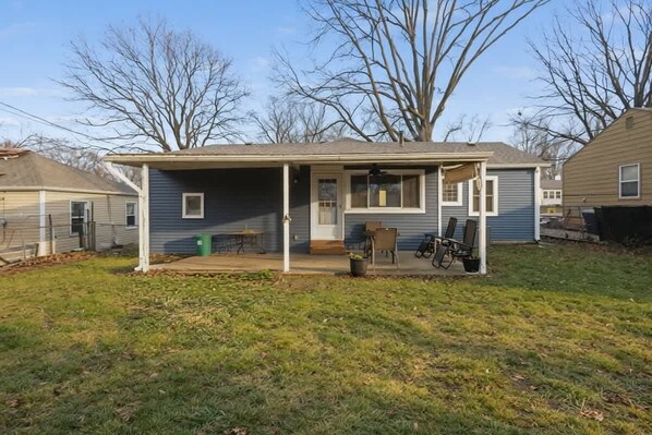 A single-story house with a covered porch, a small patio, and a bicycle parked outside.