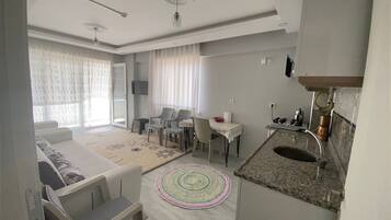 Standard Apartment, Multiple Beds, Balcony, Sea View | Living area