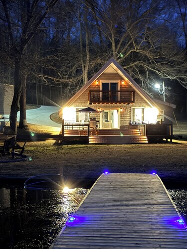 Peaceful lake house retreat with hot tub, dock, and fire pit.