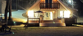 Peaceful lake house retreat with hot tub, dock, and fire pit.