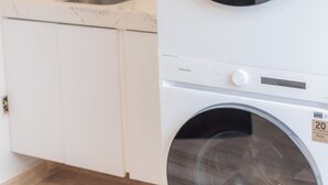 A laundry area with a washing machine and a sink. - Emma Apartments New with Pool, Jacuzzi, close to the Beach, and playgrounds (Akumal)