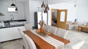 A modern kitchen with white cabinets, a black countertop, and a built-in oven. - Villa Katarina 5-bedroom near Dubrovnik with private pool (Ivanica)