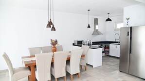 A modern kitchen with a dining area, stainless steel appliances, and pendant lighting. - Villa Katarina 5-bedroom near Dubrovnik with private pool (Ivanica)