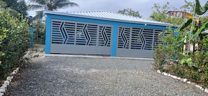 A building with a blue exterior and a gravel driveway.