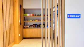 A narrow hallway with wooden paneling on the left and a blue sign reading 'EXPRESS SHOP' on the right.