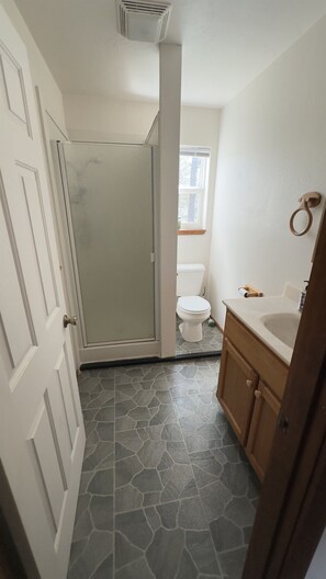 A bathroom with a shower, toilet, and sink. - 30 Night Minimum, Shasta View Chalet (Weed)