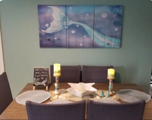 A dining table set with placemats, candles, and a welcome sign. - The Mermaid House -
Cozy, Charming and Private in Cape May County (Lower Township)