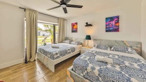 A hotel room with two beds, a ceiling fan, a window with curtains, and artwork on the walls. - Versace Vibes Retreat, Pool Sauna Near Hard Rock (Hollywood)