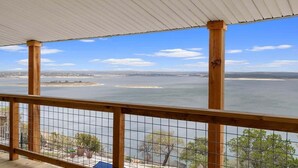 A balcony with a view of a large body of water and distant land. - Panoramic Canyon Lake Views - Retro Star Wars-Inspired Lake House (Canyon Lake)