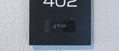 A black sign with 'Seed Inn' and '402' on a textured wall.
