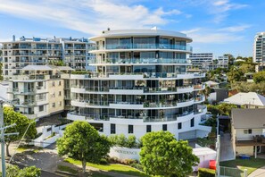 A multi-story residential building with a curved facade, balconies, and a sign labeled 'PROVIDENCE'. - Providence Oceanview Retreat with Pool & Spa (Caloundra Region)