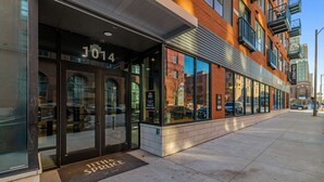 A building with a glass storefront, a fire escape, and a fire hydrant outside.