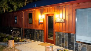 A wooden building with a sign reading 'WELCOME' and a door.