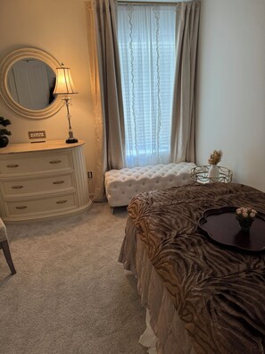 A bedroom with a bed, a dresser, a mirror, and a window with curtains. - Cozy private bedroom in shared home in serene Fishers neighborhood (Fishers)