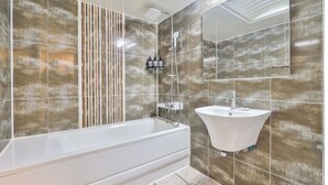 A modern bathroom with a freestanding bathtub, a wall-mounted sink, and a large mirror. - Page 9 Hotel (Seoul)