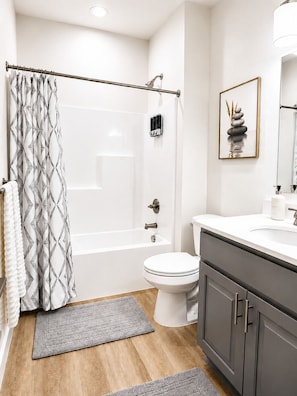 Un baño moderno con bañera, inodoro y tocador.