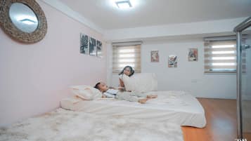 Une chambre à coucher avec un lit, un tapis moelleux et un miroir au mur.