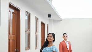 A building with white walls and wooden doors. - Woodlands Condotel (Bulan)